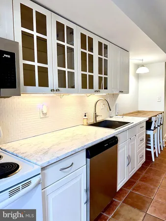 a hallway with a large mirror and a sink
