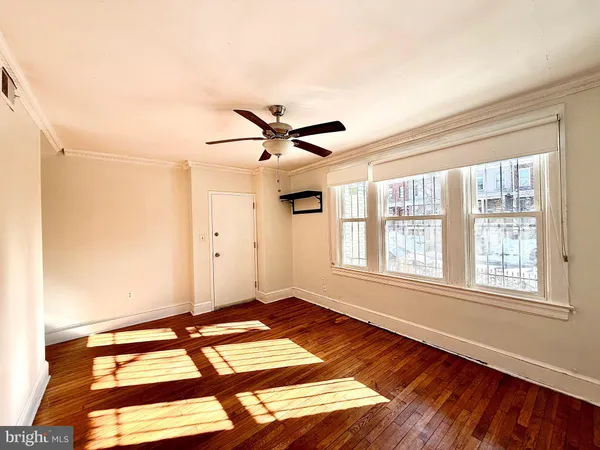 a view of a room with a window and wooden floor