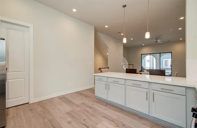 a large white kitchen with a sink
