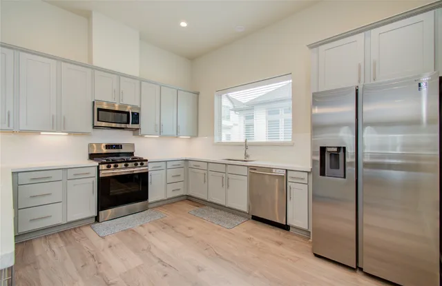 a kitchen with granite countertop stainless steel appliances and wooden cabinets
