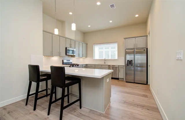 a large kitchen with a table and chairs