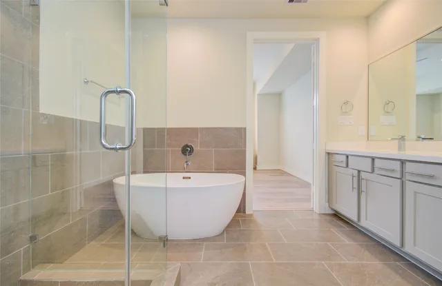 a spacious bathroom with a bathtub and shower