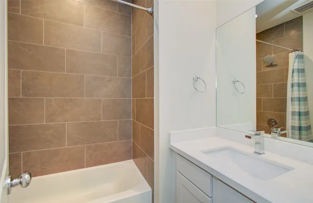 a bath tub sitting next to a white sink