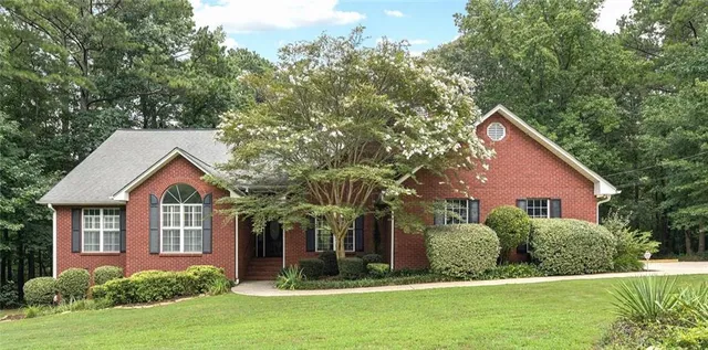 a view of a house with a yard and garage