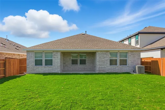 a front view of a house with yard and green space