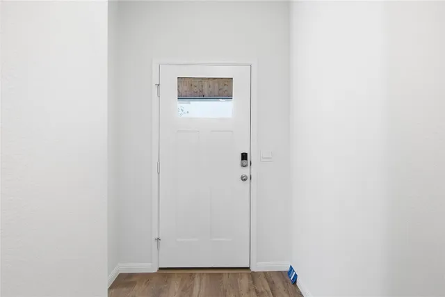a view of a hallway with wooden floor