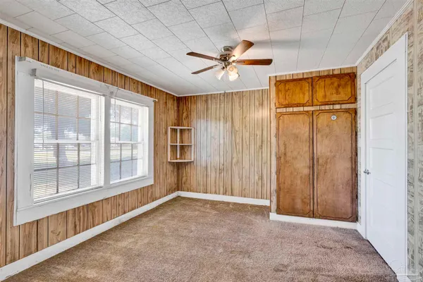 an empty room with windows and entrance
