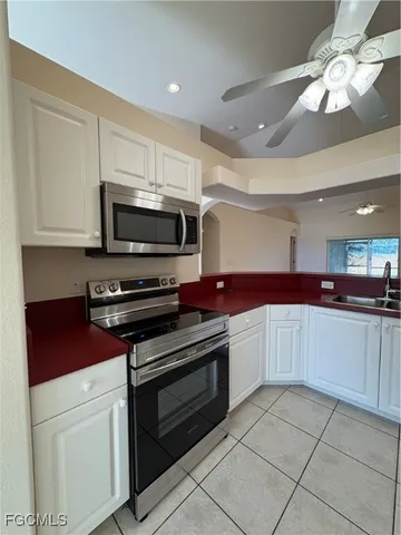 a kitchen with stainless steel appliances a refrigerator sink and cabinets