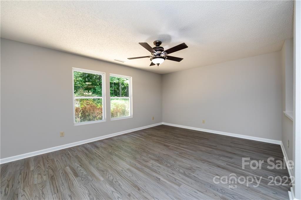 776 Ladino Lane Clover, SC 29710 - Photo 12 of 44 an empty room with wooden floor and windows