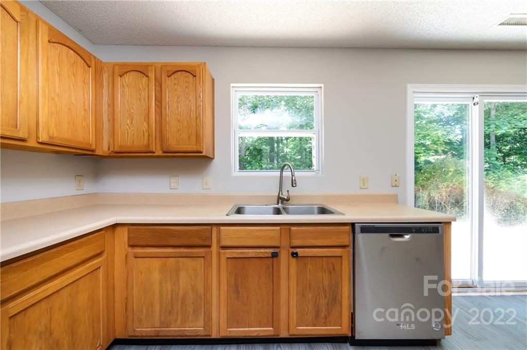 776 Ladino Lane Clover, SC 29710 - Photo 19 of 44 a kitchen with stainless steel appliances granite countertop a sink a microwave cabinets and a window