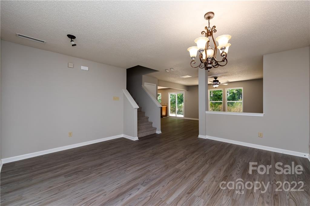 776 Ladino Lane Clover, SC 29710 - Photo 8 of 44 a view of a room with wooden floor chandelier and windows