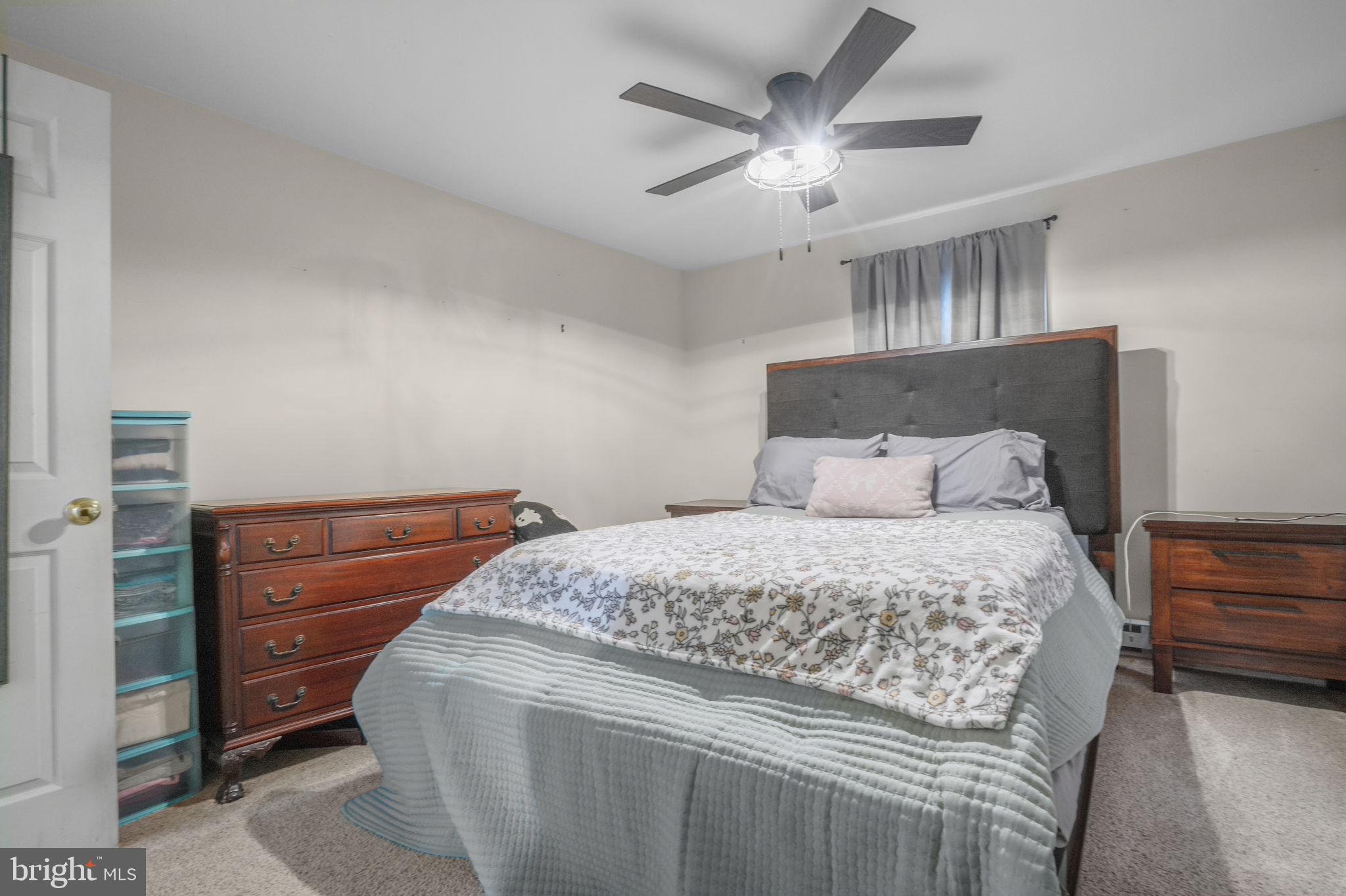 7278 Fleming Road New Church, VA 23415 - Photo 19 of 44 a bedroom with a bed and a chandelier