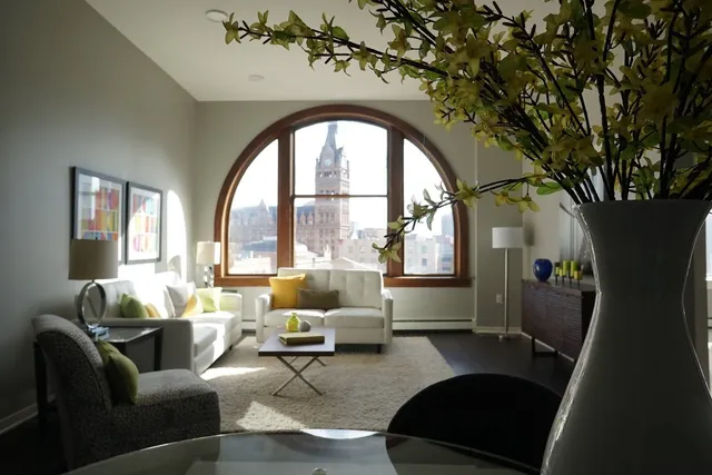 a living room with furniture and a large window