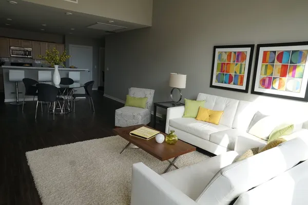 a living room with furniture and a book shelf