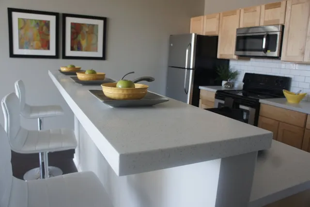 a kitchen with stainless steel appliances a microwave a stove and refrigerator