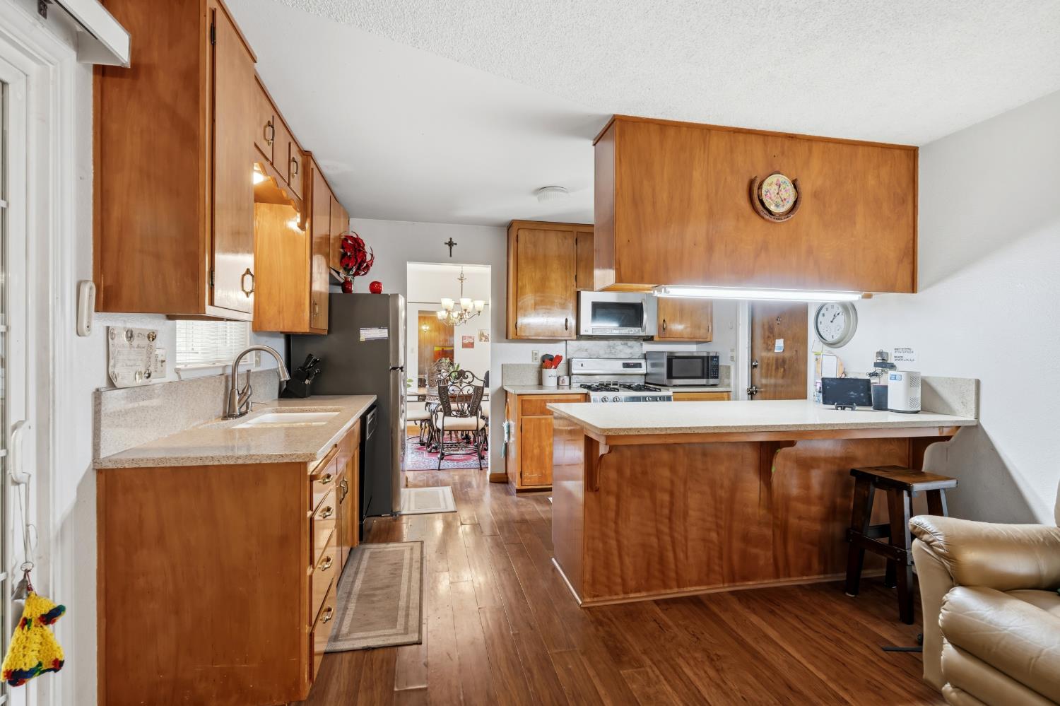 3356 Ocotillo Way Modesto, CA 95355 - Photo 11 of 33 a kitchen with stainless steel appliances granite countertop a sink a stove and refrigerator