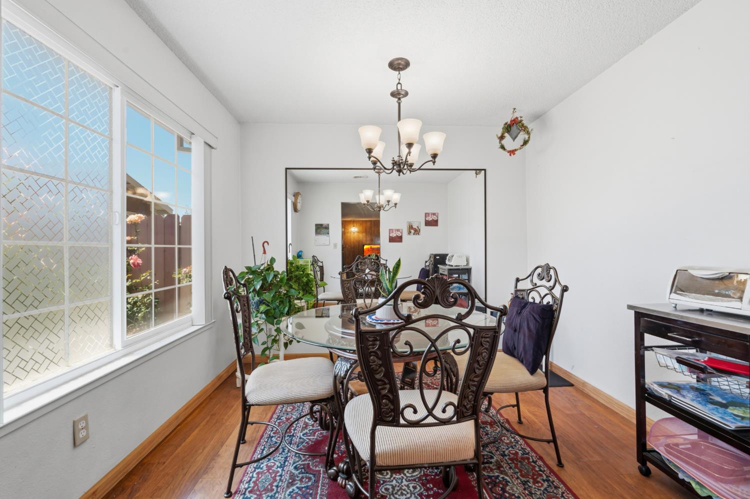 3356 Ocotillo Way Modesto, CA 95355 - Photo 14 of 33 a view of a dining room with furniture wooden floor and a chandelier