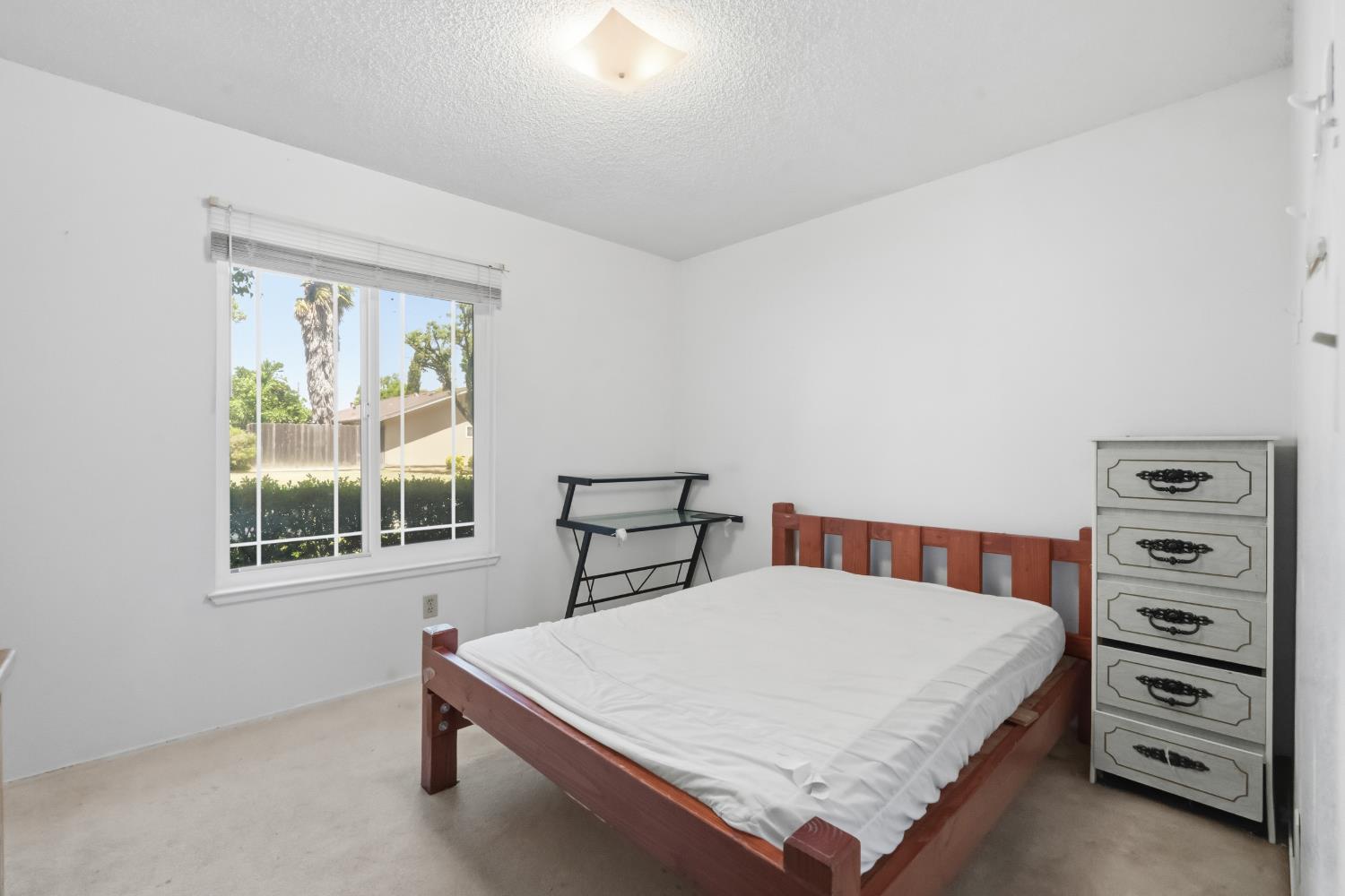 3356 Ocotillo Way Modesto, CA 95355 - Photo 16 of 33 a bedroom with a bed a table and a window