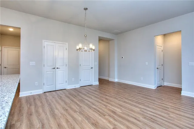 a view of an empty room and window and wooden floor