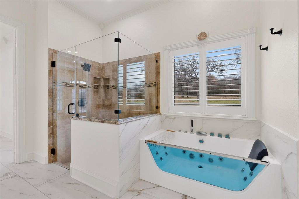 531 East Hickory Ridge Circle Argyle, TX 76226 - Photo 19 of 37 a bathroom with a tub sink and mirror