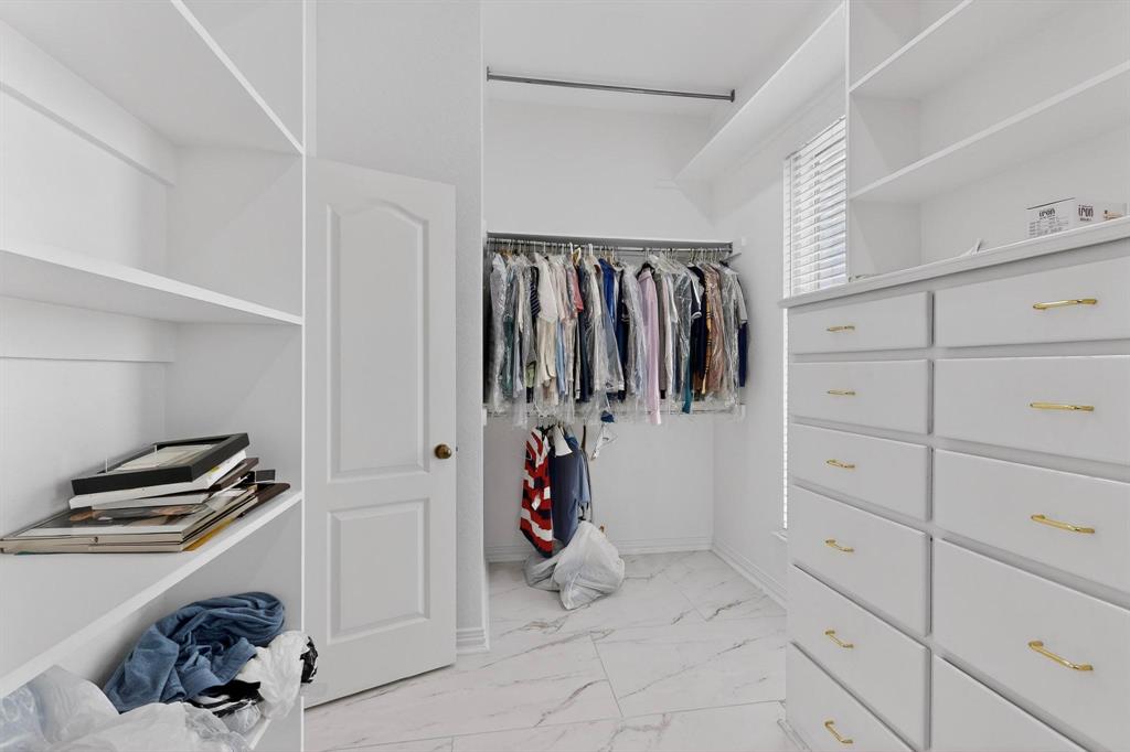 531 East Hickory Ridge Circle Argyle, TX 76226 - Photo 27 of 37 a view of walk in closet with clothes and shoes