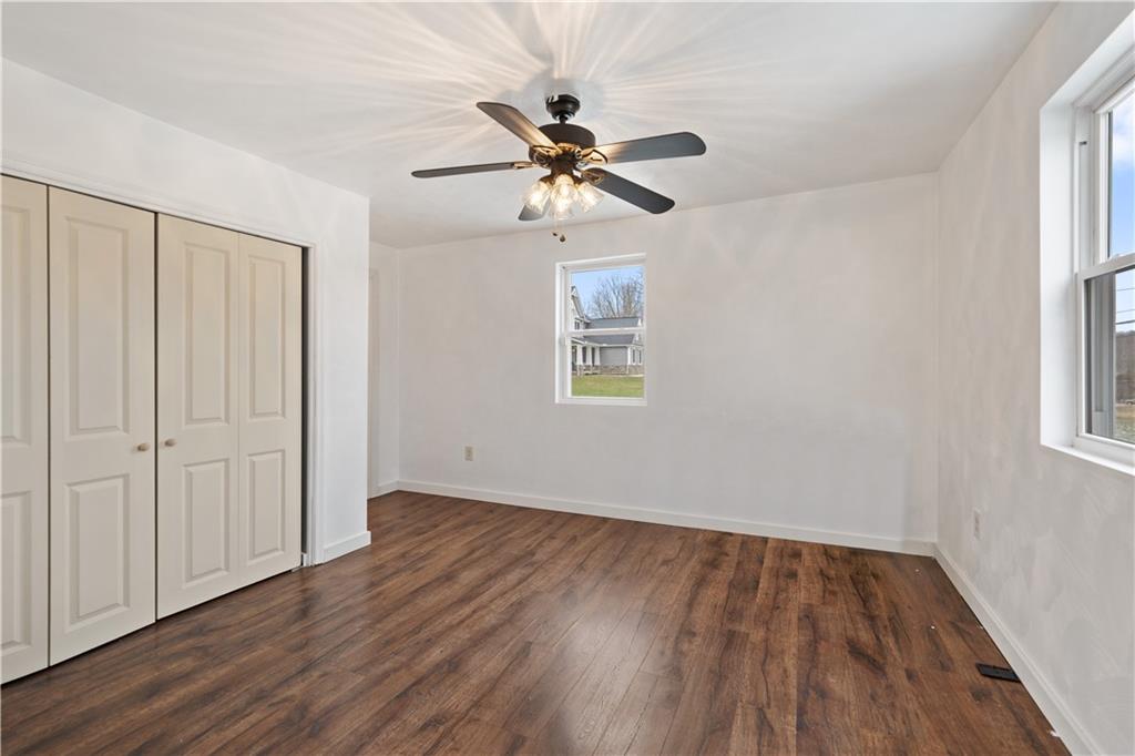 607 Fayette City Road Perryopolis, PA 15473 - Photo 11 of 31 an empty room with wooden floor closet and windows