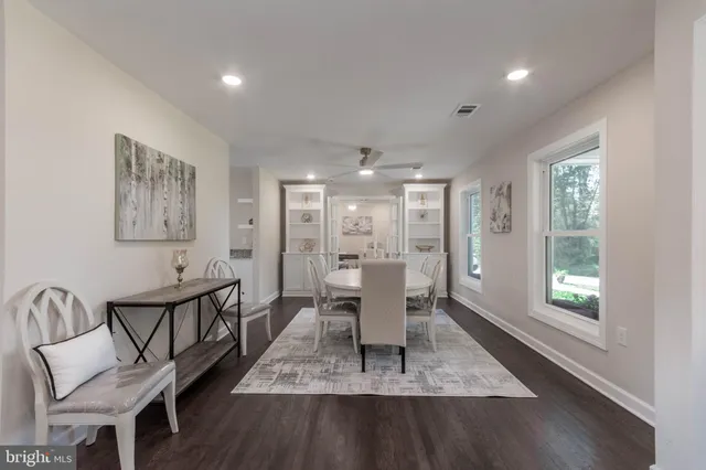 a view of a a dining room with furniture window and wooden floor