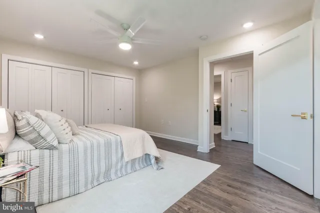 a kitchen with counter top space a sink appliances and windows