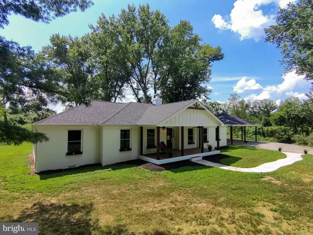 a view of a house with a yard porch and sitting area