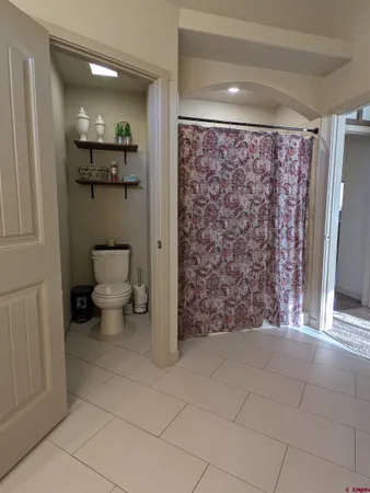 a bathroom with a granite countertop sink a mirror and shower