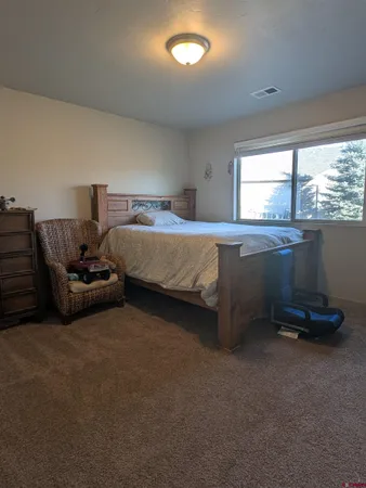 a view of a house with a yard and garden