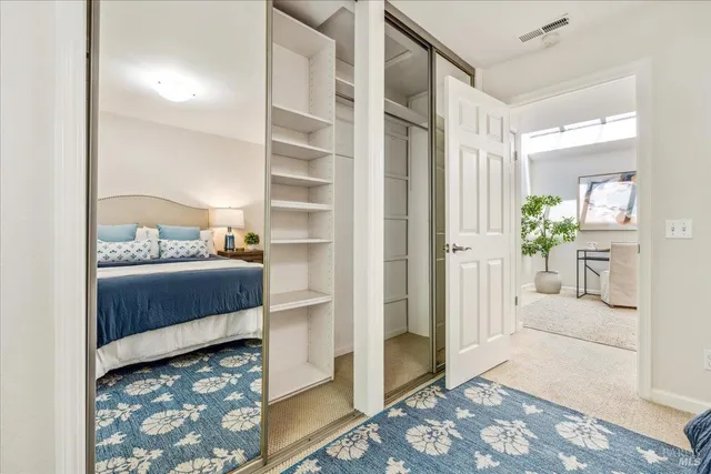 a bedroom with furniture and a rug