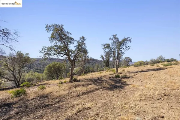 a view of dirt yard and mountain view