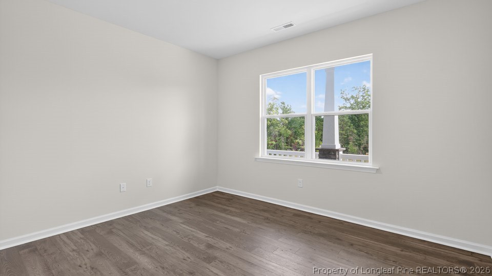152 Charlies Bnd Way Spring Lake, NC 28390 - Photo 4 of 34 an empty room with wooden floor and windows