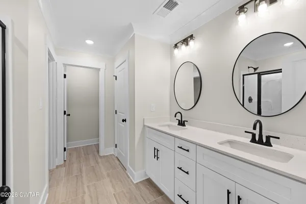 a bathroom with a double vanity sink and a mirror