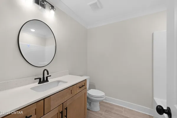 a bathroom with a sink a mirror and a toilet
