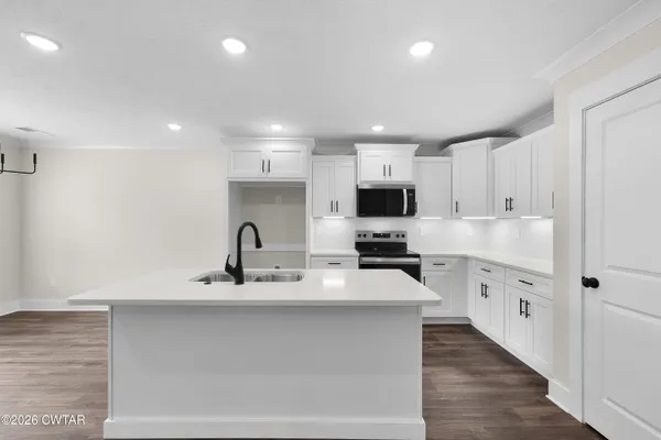a kitchen with cabinets a sink and appliances