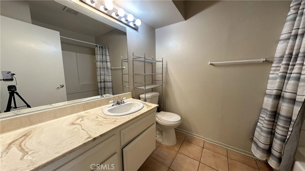 49409 Eisenhower Drive Indio, CA 92201 - Photo 9 of 30 a bathroom with a sink a toilet a mirror and shower