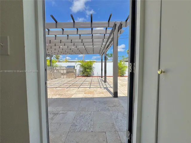 a view of a patio with a table and chairs