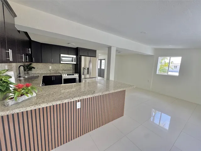 a view of a kitchen from a dining room