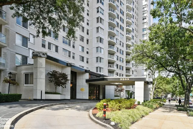 a front view of a building with a garden