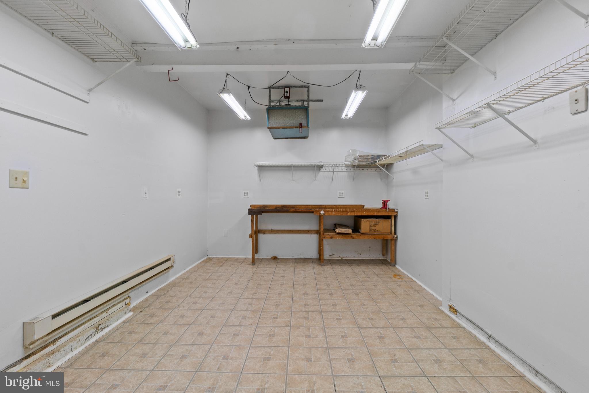 8617 Sherington Road Nottingham, MD 21236 - Photo 33 of 36 Workshop With Vinyl Tile FloorAnd Shelving