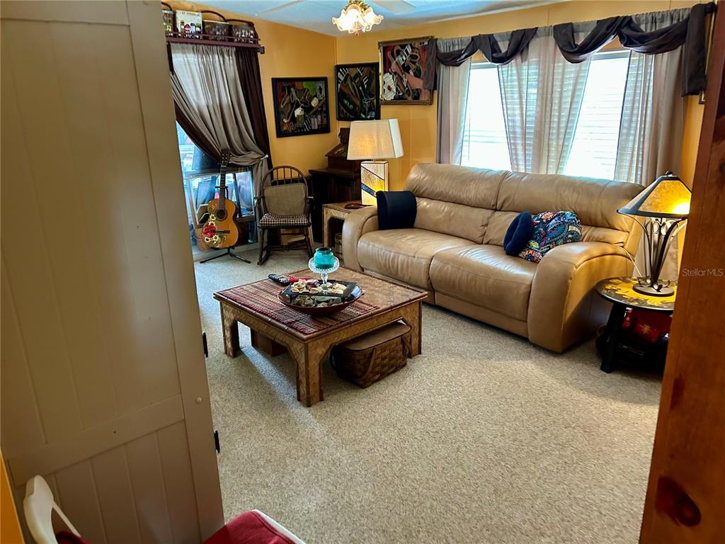 25646 Bass Road Astor, FL 32102 - Photo 20 of 48 a living room with furniture and a window