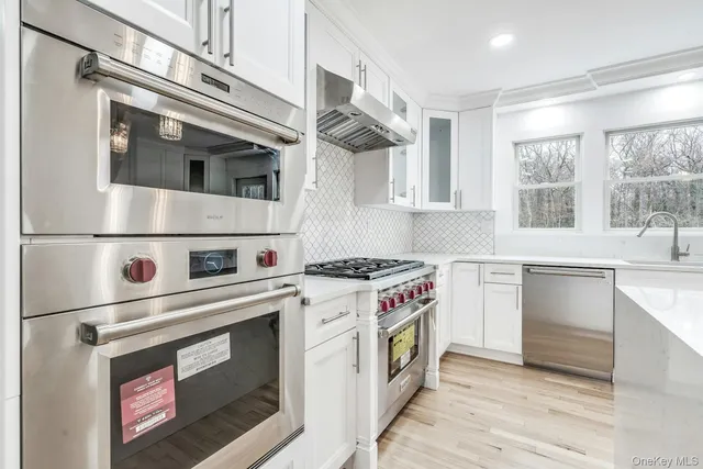 a kitchen with stainless steel appliances granite countertop a stove and a sink