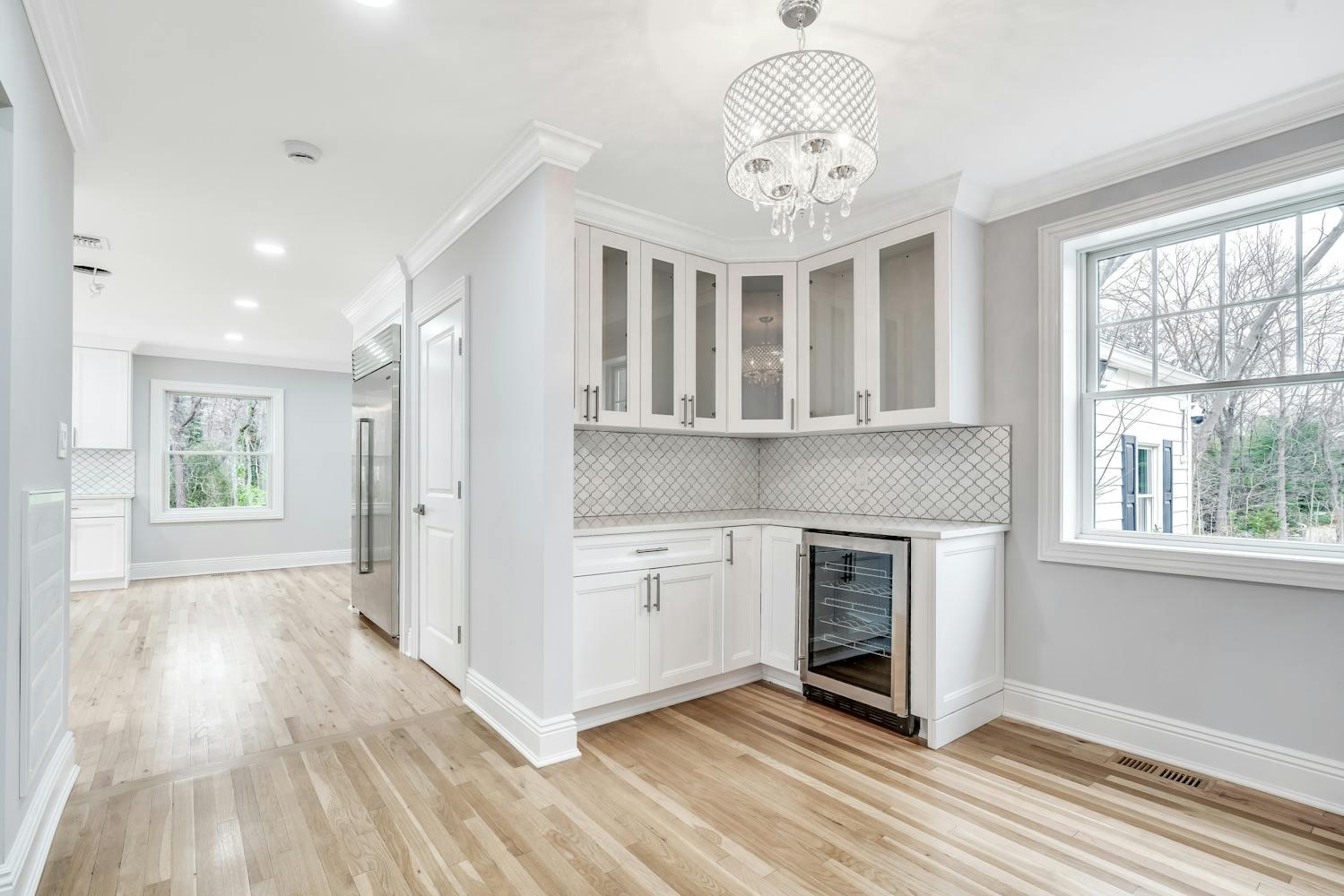539 Split Rock Road Syosset, NY 11791 - Photo 19 of 40 a view of a hallway with wooden floor and a kitchen