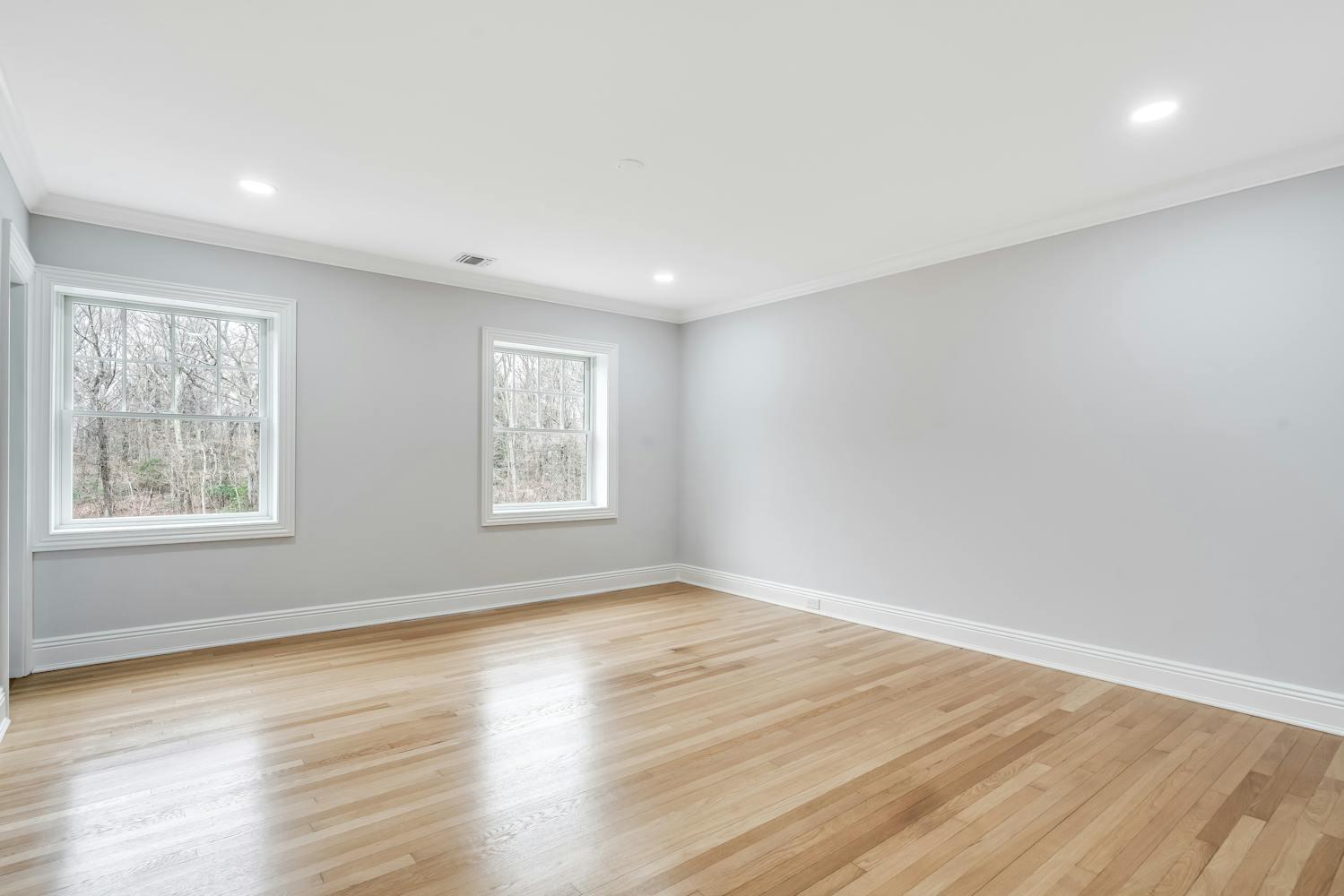 539 Split Rock Road Syosset, NY 11791 - Photo 23 of 40 a view of an empty room with wooden floor and a window
