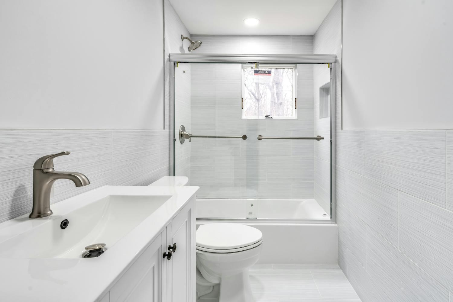539 Split Rock Road Syosset, NY 11791 - Photo 32 of 40 a bathroom with a sink toilet and shower