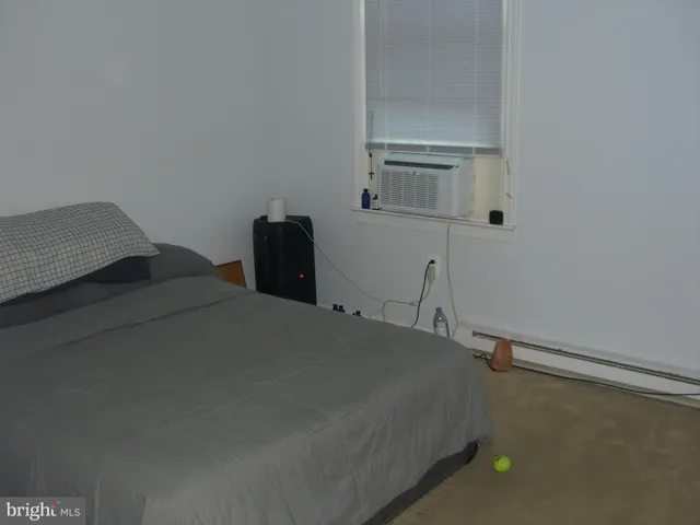 a bedroom with a bed and a night stand