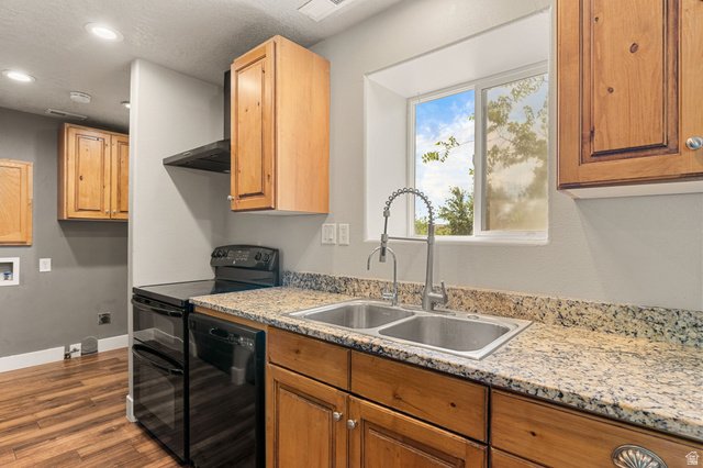 55 Spring Drive Toquerville, UT 84774 - Photo 12 of 36 Kitchen with black appliances, light stone countertops, dark wood-style flooring, recessed lighting, and wood finish cabinetry