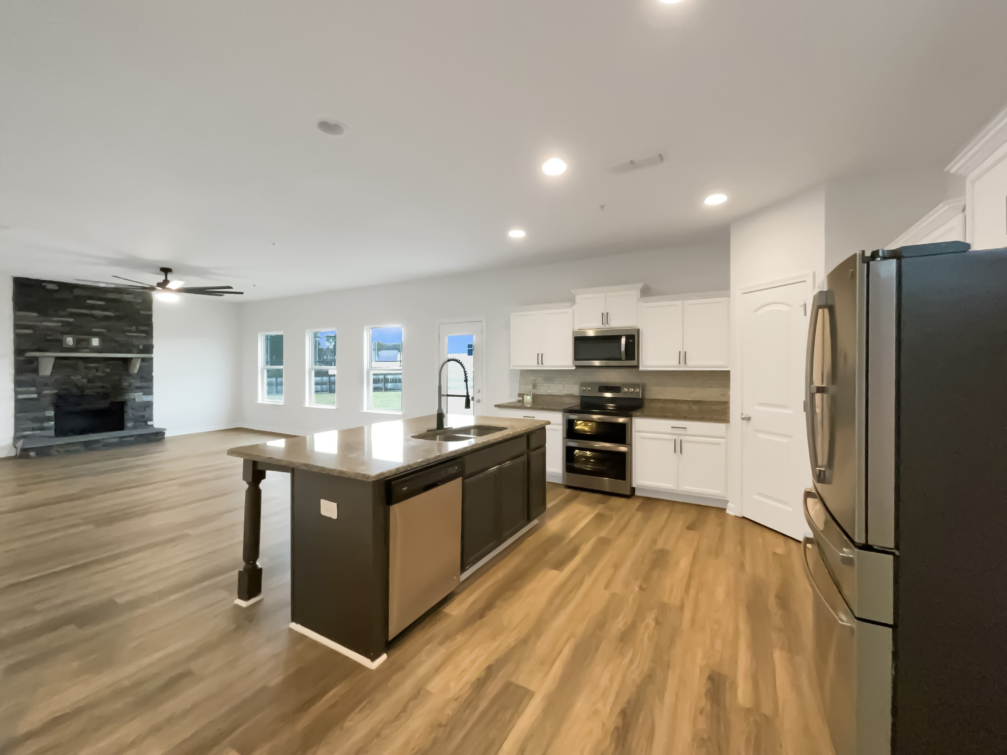 203 Fount Hackney Lane Murfreesboro, TN 37129 - Photo 11 of 26 a kitchen with stainless steel appliances granite countertop a stove top oven and refrigerator